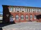 A brick building at Saxonville Mills with many windows